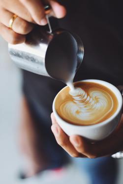 cup of amazing coffee someone is pouring